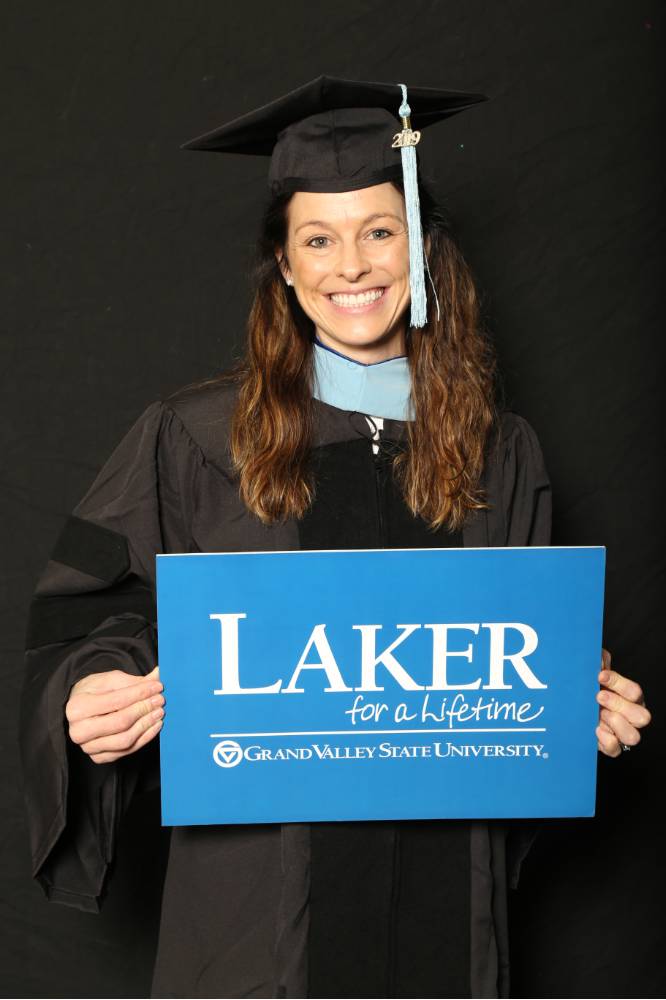 masters graduate with laker for a lifetime sign